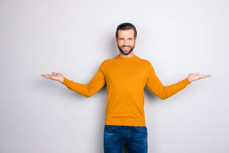 Portrait of delightful confident expert attractive bearded guy demonstrating balance  giving two...