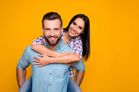 Portrait with copy space of lovely romantic couple, handsome man carrying on back charming woman...