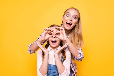 Joke positive emotion face facial expression adventure look health care concept. Portrait of two funky amazed shocked cute girls fooling around making eyeglasses with hands isolated bright backgroundの写真素材