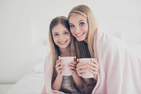 Enjoy time chat conversation lifestyle winter autumn warmth close relatives concept. Beautiful joyful excited pretty with toothy smile ladies having tea party at home covering shoulders with plaidの写真素材