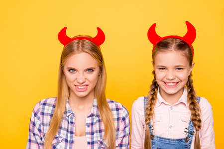 Teen age teenager adult concept. Close up portrait of little scaring funky beautiful cute girl with pigtails in overalls attractive terrifying with long hair woman isolated on bright vivid backgroundの写真素材
