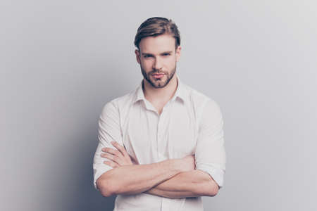 Glance people person ceo career director executive inspector inspection auditor respect concept. Portrait of  proud confident banker standing with crossed hands isolated on gray background copyspaceの写真素材