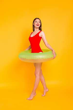 Travel tourism tourist resort lifestyle leisure dream dreamy people person concept. Vertical full length size body photo portrait of lovely girl with green lifebuoy isolated bright backgroundの写真素材