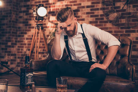 Overworked bad mood regret disappointment exhausted chill handover headache suffer lonely lost concept. Sad upset unhappy tired frustrated troubled pensive serious guy analyzing his fail in businessの写真素材