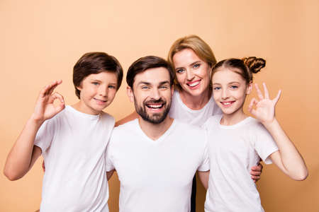 Portrait of adorable attractive beautiful family, bearded father, blonde mother and their little...