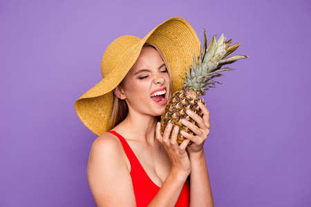 People person facial funny emotion expressing concept. Close up photo portrait of pretty humor comic bright shiny student on holiday tasting fresh ananas isolated vivid backgroundの写真素材