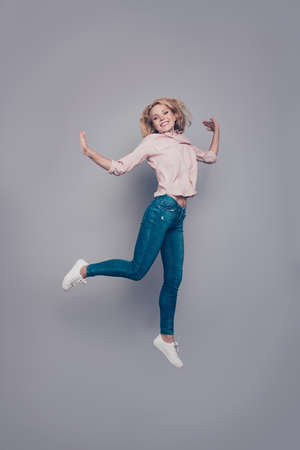 Full body length size portrait of attractive beautiful curly-haired blonde caucasian young girl...