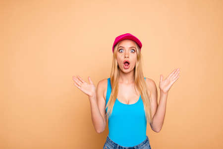 Young attractive nice cute straight-haired shocked blonde girl wearing casual, bright vivid cap,...