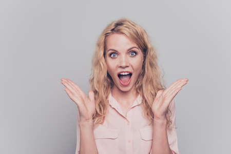 Girl shocked by the good news! Young model looks at the camera with wide open mouth and eyes...