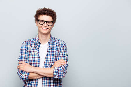 Portrait with copy space and empty place for text with young man in glasses with crossed arms...