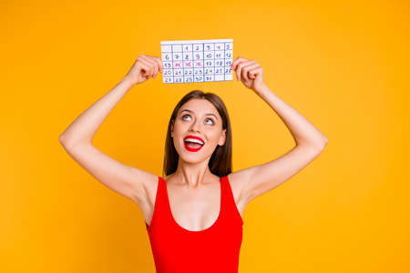 Journey travel trip tourism tourist people person leisure delight concept. Photo portrait of pretty laughing cool dreamy cheerful joyful pleased lady holding calendar over head isolated backgroundの写真素材