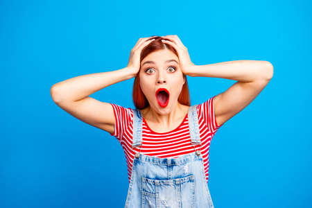 Sale discount black friday person people concept. Close up studio photo portrait of humorous terrified astonished lady touching head with hands looking at camera isolated bright vivid backgroundの写真素材