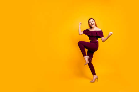 Full body size length view photo portrait of funky comic cool nice glad cheerful joyful carefree girl wearing burgundy suit running going moving lady raising fists up isolated bright backgroundの写真素材