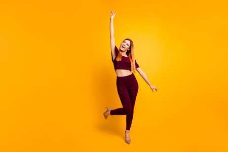 Full-size portrait of cool and charming happy woman isolated on yellow background with copy space...