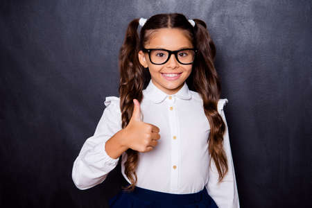 Portrait of cheerful nice adorable cute lovely small little girl with curly ponytails in white...