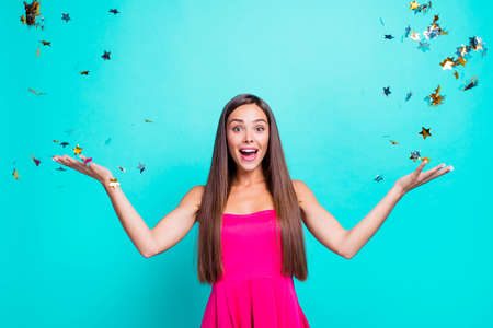 Close up studio photo portrait of astonished wondered cheerful joyful cute lovely charming nice cool look staring eyes lady catching confetti isolated on bright shine backgroundの写真素材