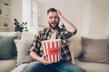 Concept of winner and loser. Brunet man holding his head and watの写真素材