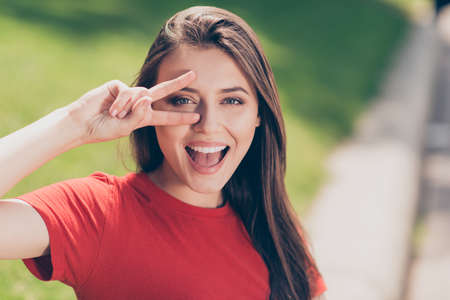 Close up portrait of  cheerful girl in a red T-shirt that shows