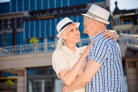 Portrait of romantic lovely couple in straw hats embracing overの写真素材