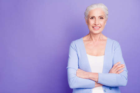 Portrait of confident elderly woman looking at camera with arms