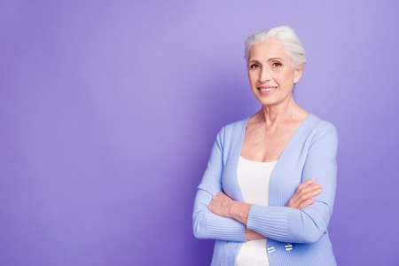 Grey haired old nice beautiful smiling woman with crossed hands,