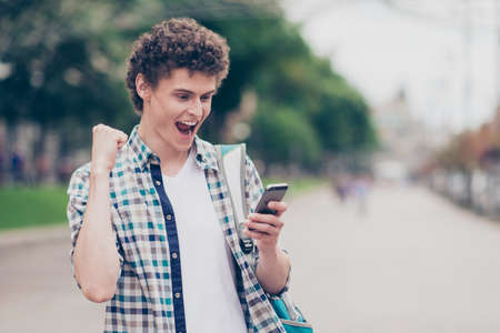 Winner concept. Curly haired cute attractive handsome guy wearinの写真素材