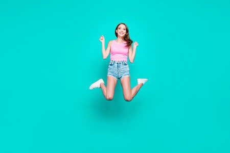 Full-legh portrait of happy brunette student girl in jump isolatの写真素材