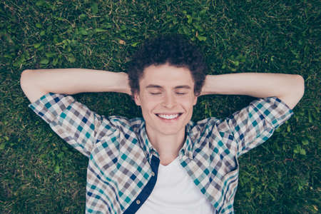 Curly haired cute attractive smiling handsome guy wearing casualの写真素材