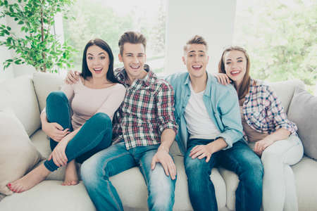 Four attractive nice young caucasian friends, two couples, weari