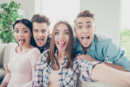 Cute, expression, glad hipsters in stylish casual wear take self