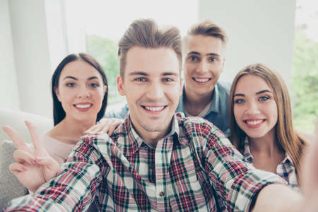 Close uo photo of four youngster in checkered shirt that make seの写真素材