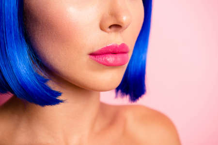 Close up cropped beautiful, half face and half turn portrait of pink augmentation lips young person woman isolated on pastel backgroundの写真素材