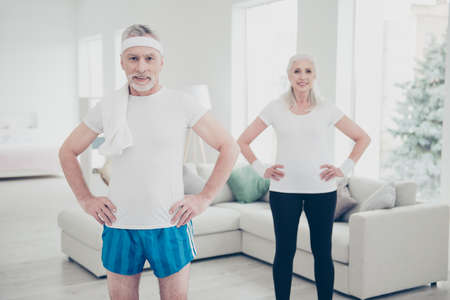 Two adorable healthy charming stylish old people doing physical