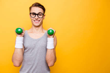 Portrait of masculinity man hold dumbbells in hands and make bigの写真素材