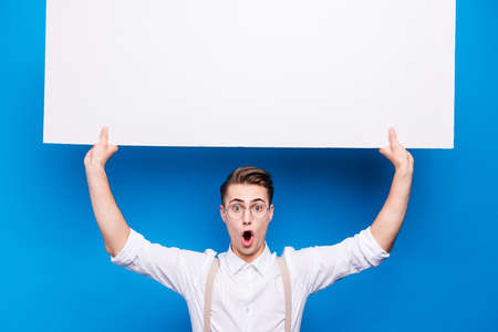 Portrait of cute, nice-looking youngster man with wide open moutの写真素材