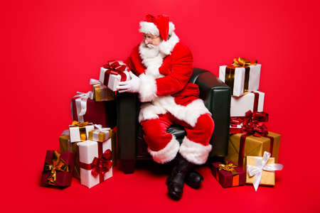 Full legs body size Santa with white beard hold look small packageの写真素材