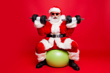 Cheerful sporty muscular virile strong Santa in white fluffy ballの写真素材