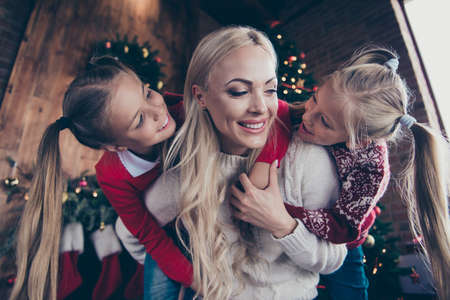 Low angle top view careless carefree glad blonde mama and her daughter