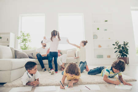 Cute, sweet, little kids drawing beautiful pictures for parentsの写真素材