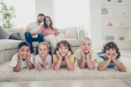 Photo of beautiful multiethnic five children lay near blurredの写真素材