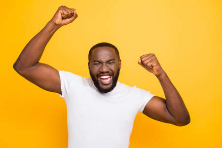 Handsome attractive manly cheerful glad mulatto man, showing win