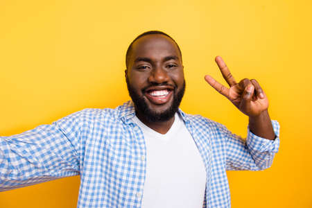 Self-portrait of handsome cheerful positive mulatto man in casual