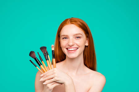 Woman with smiling face and holding brushes close up.の写真素材