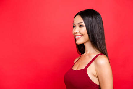 Portrait of girl posing with red background.