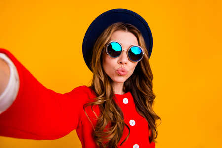 Woman wearing sun glasses  with orange background.の写真素材