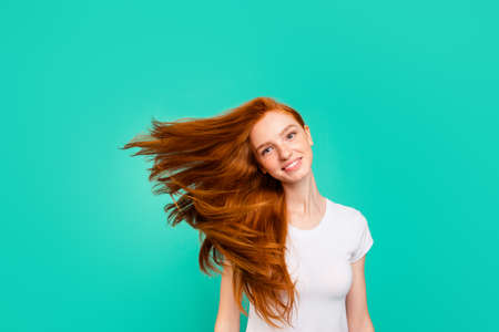 Dynamic image of pretty, dreamy, attractive, charming, lovely, cute, beautiful, sweet, gorgeous girl in white t-shirt casual wear isolated on bright mint backgroundの写真素材