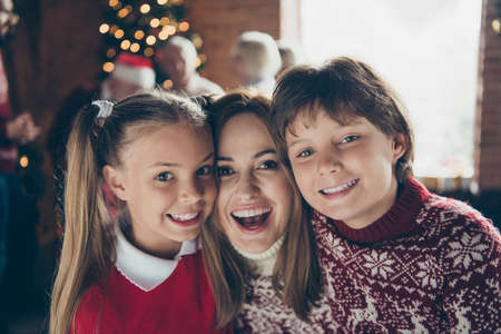 Portrait of cheerful mom with siblings. Noel morning gathering.の写真素材