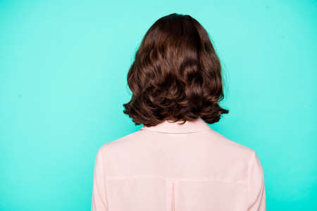 Rear back closeup view of pretty attractive mysterious lady with curly wavy ideal hair isolated over turquoise green teal pastel backgroundの写真素材