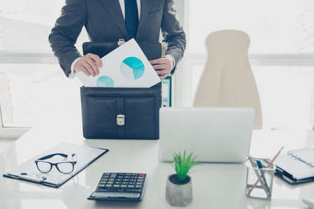 Cropped photo of expert man in formalwear prepare to conference fold papers into a briefcaseの写真素材