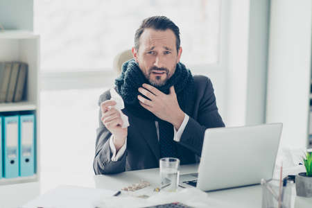 Accountant advocate agent attorney analyst person look at camera with miserable exhausted face in trend formalwear sit on armchair chair behind table with modern technology hold hand on neckの写真素材
